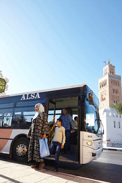 people getting off an ALSA urban bus in Marrakech by Janie Airey photographer
