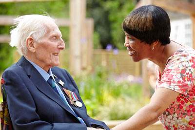 elderly care home resident with care worker at Royal Star & Garter by Janie Airey photographer
